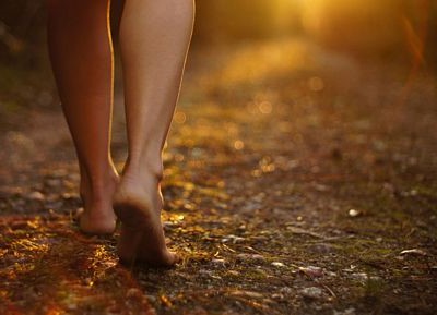 closup of legs of a woman walking in evening sun